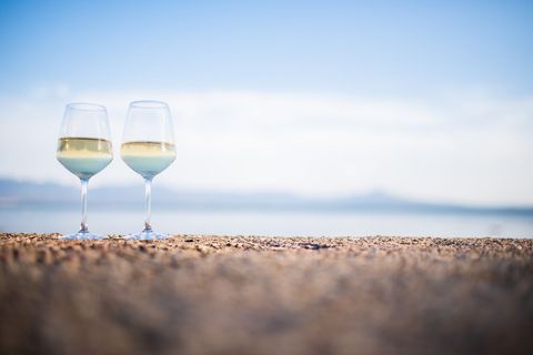 Two Glasses of White Wine on Beach Overlooking Ocean