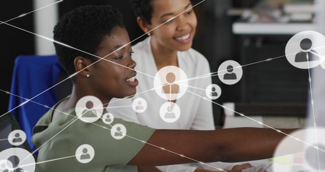 Two businesswomen are collaborating in an office, with a digital network overlay ceiver symbolizing professional connections and teamwork. This can be used for themes like corporate communication, technology in business, and office environments.