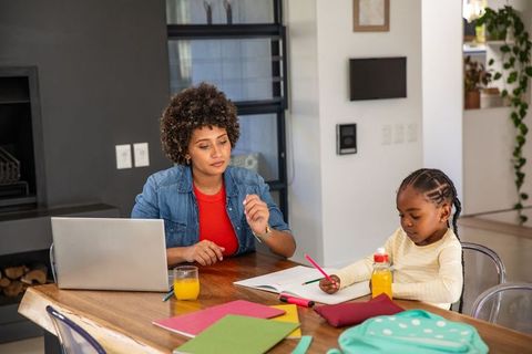 Mother and Child Engaging in Homeschool Learning Activity at Home