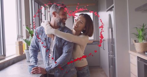 Happy Couple Embracing in Sunlit Modern Kitchen