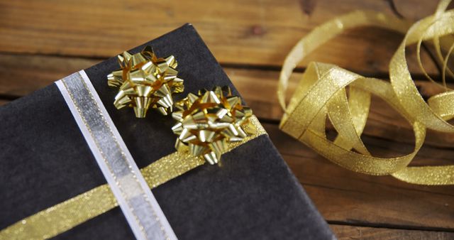 Gift Box with Golden Ribbon and Bow on Wooden Table - Download Free Stock Images Pikwizard.com