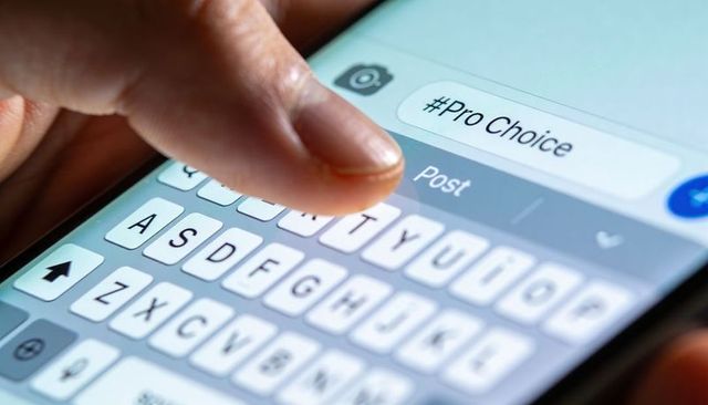 Tapping Pro-Choice Hashtag on Smartphone Touchscreen Posting Social Media Activism