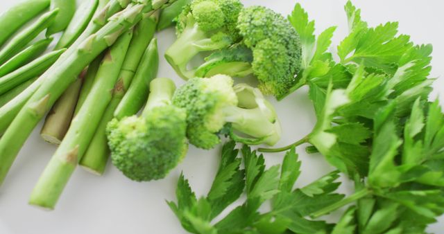 Image of close up of fresh green vegetables on white background. fusion food, fresh vegetables and healthy eating concept.