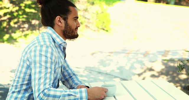 Man with Man Bun Drinking Coffee Outdoors - Download Free Stock Images Pikwizard.com