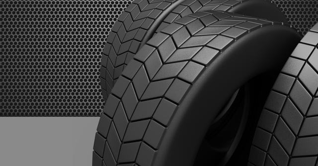 Detailed view of black tire tread patterns highlighting the texture and design, set against a modern perforated metal background. Ideal for use in automotive advertisements, tire industry promotions, manufacturing brochures, and mechanical workshop websites. Emphasizes durability and quality of automotive products.