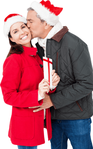 Festive mature couple joyfully exchanging christmas gift with warm greeting