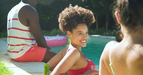 Smiling Friends Relax Poolside on a Sunny Day