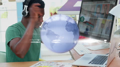 Graphic Designer Working with Digital Globe Icon Overlay