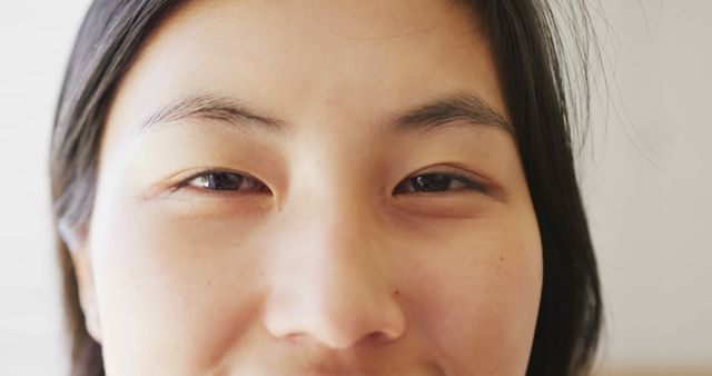 Portrait of happy asian woman opening her eyes and looking at camera. Spending quality time at home concept.