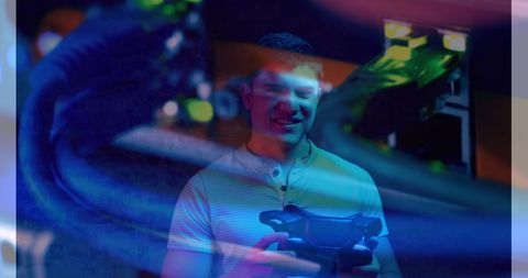 Young Man Holding Virtual Reality Headset with Tech Overlay - Download Free Stock Images Pikwizard.com