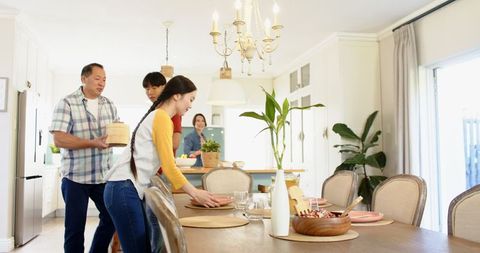 Asian Family Preparing Meal in Modern Bright Kitchen