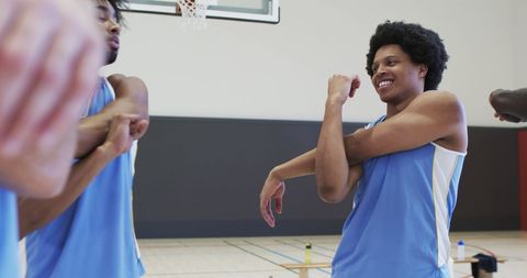 Diverse Basketball Team Members Stretching on Indoor Court - Download Free Stock Images Pikwizard.com