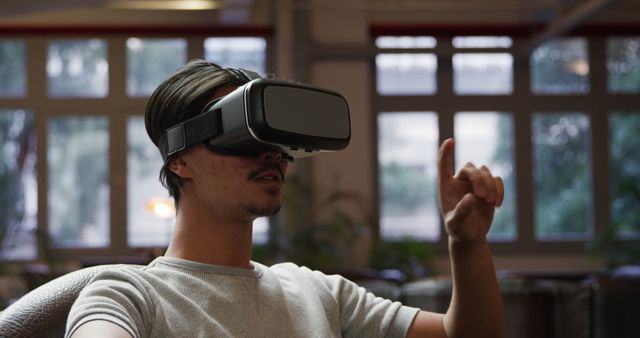 Man Experiencing Virtual Reality with VR Headset at Office - Download Free Stock Images Pikwizard.com