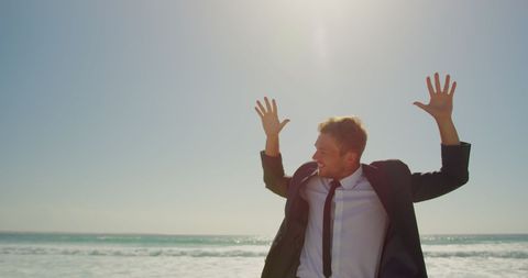 Joyful Businessman Dancing on Sunny Beachfront - Download Free Stock Images Pikwizard.com