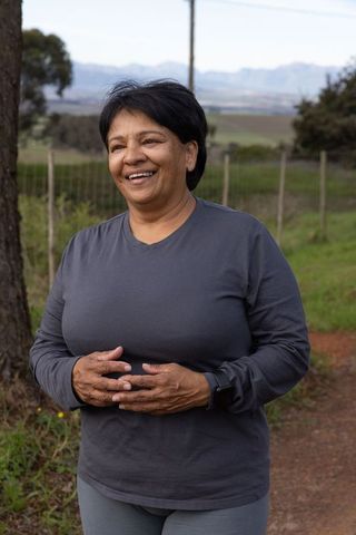 Senior Woman Enjoying Leisurely Outdoors Walk with Fitness Focus