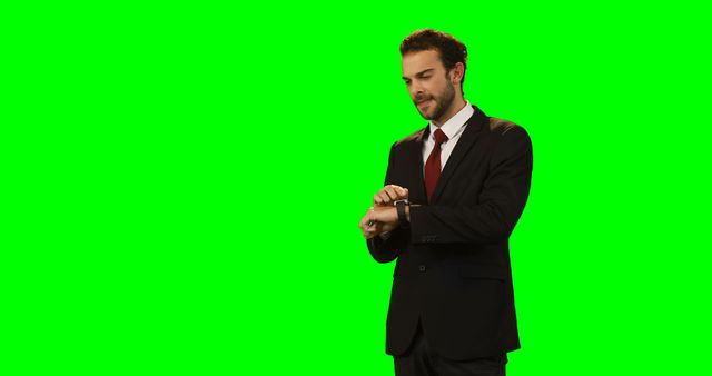 Businessman Checking Smartwatch Against Green Screen - Download Free Stock Images Pikwizard.com