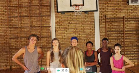 Diverse basketball team receiving guidance from coach
