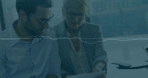 Executives Collaborating and Reviewing Financial Data with Digital Waveform Overlay
