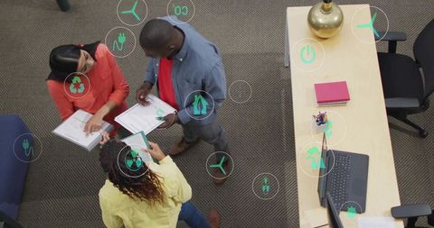 Sustainable Business Meeting with Eco-Friendly Icons and Team Collaboration