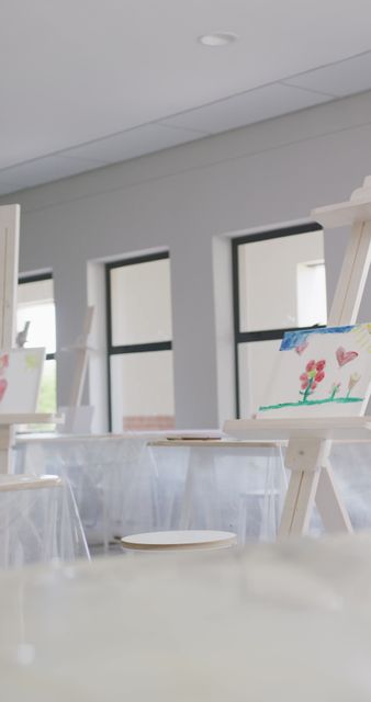 Empty Art Classroom with Paintings on Easels in Bright Natural Light - Download Free Stock Images Pikwizard.com