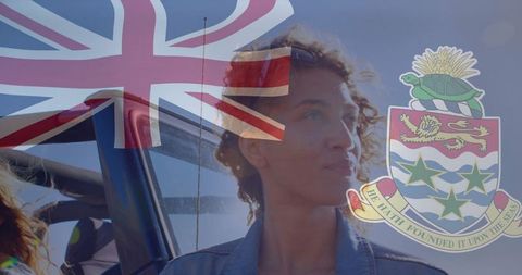 Confident woman posing by suv with british ensign flag overlay