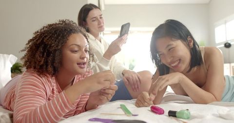 Diverse Friends Having Fun Nail Care at Home
