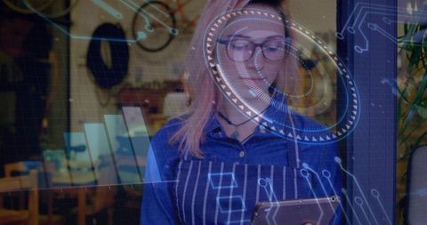 Barista holding tablet wearing striped apron and glasses viewing augmented reality hud