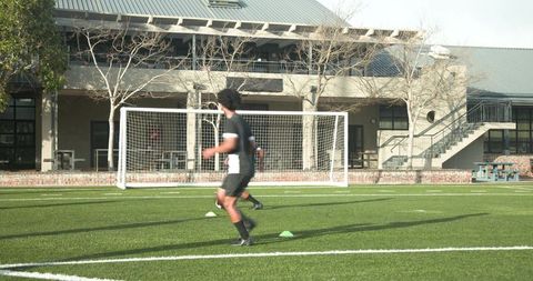 Young Soccer Player Practicing Drills on Field