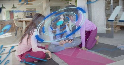 Friends exploring fitness app on tablet with ar overlays during home yoga
