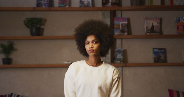 Confident Woman with Curly Hair Standing in Contemporary Living Room - Download Free Stock Images Pikwizard.com