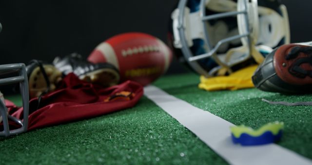 Football Gear on Turf Field with Helmet, Ball, Gloves, and Mouthguard - Download Free Stock Images Pikwizard.com