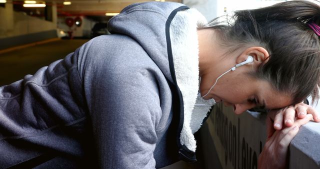 Woman Resting in Parking Garage After Workout - Download Free Stock Images Pikwizard.com