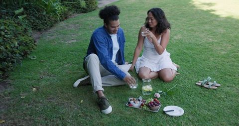 Couple Relaxing Outdoors with Fresh Fruits during Picnic in Park