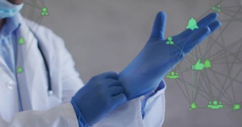 Medical professional donning blue nitrile gloves with digital connectivity icons