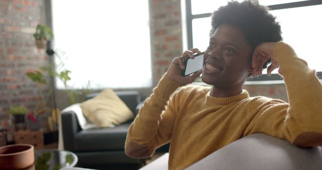 Smiling Woman Talking on Phone at Home in Relaxed Setting - Download Free Stock Images Pikwizard.com