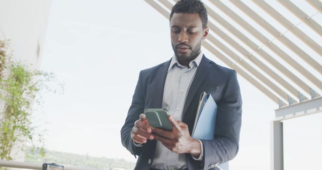 African american businessman using smartphone at office. Business, corporation, working in office and cooperation concept.