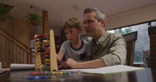 Father Teaching Son with Abacus During Homework - Download Free Stock Images Pikwizard.com