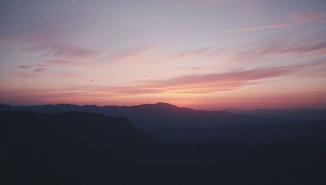 Majestic Mountain Silhouette at Dawn with Textured Sky