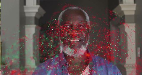 Smiling Senior Man Showered in Festive Confetti Lights