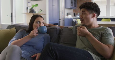 Happy Couple Enjoying Coffee on Sofa in Modern Living Room - Download Free Stock Images Pikwizard.com