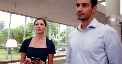 Young professionals discussing work colleagues in office