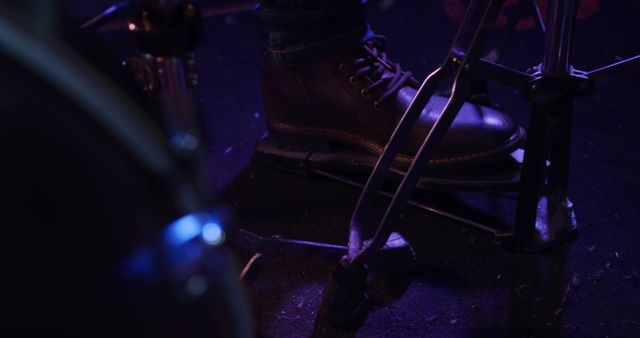 Foot of drummer on bass drum pedal playing drums at band practice, copy space. Music, practice, creativity and lifestyle, unaltered.