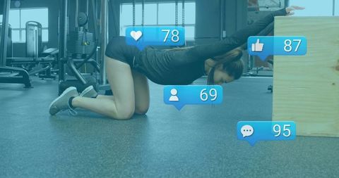 Fitness Enthusiast Stretching in Gym with Social Media Interaction