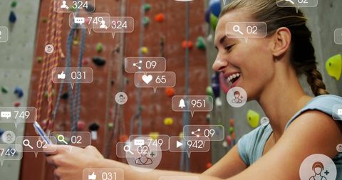Woman Engaging on Social Media at Climbing Gym