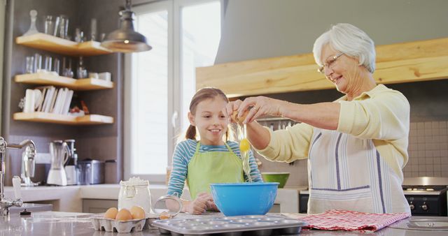 Senior Woman Sharing Baking Lesson with Young Girl In Home Kitchen Moment of Family Bonding - Download Free Stock Images Pikwizard.com