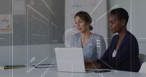 Businesswomen Analyzing Charts in Corporate Meeting Room