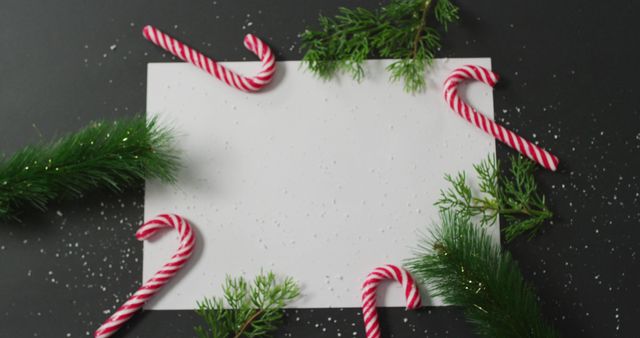Perfect for adding personalized holiday messages or Christmas greetings, this festive frame features classic candy canes and vibrant evergreen branches against a dark background. It can be used for greeting cards, holiday invitations, festive posters, or digital holiday wishes to friends and family.