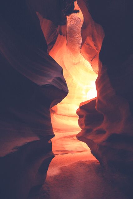 Sunlight shining through the narrow passageways of Antelope Canyon, highlighting the red sandstone textures and patterns. Ideal for use in travel brochures, nature documentaries, geology presentations, or as inspiring wall art. Captures the beauty of natural landscapes and the serenity of desert canyons.