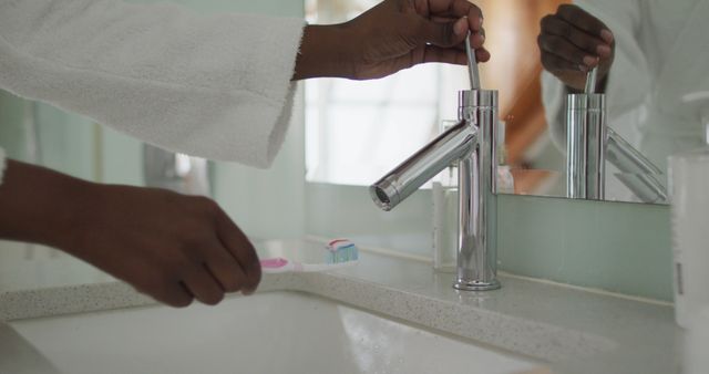 Close-up of Person Turning Faucet and Holding Toothbrush in Modern Bathroom - Download Free Stock Images Pikwizard.com