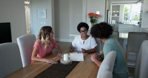 Young couple meeting with professional for paperwork discussion